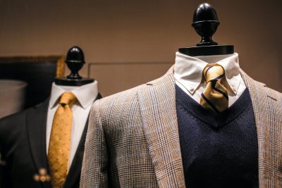 elegant male outfits on dummies in modern boutique